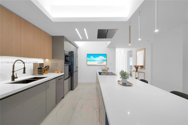 10700 NW 66th St Unit 103, Doral, FL 33178 - kitchen with a sink, light marble finish floors, modern cabinets, and oven