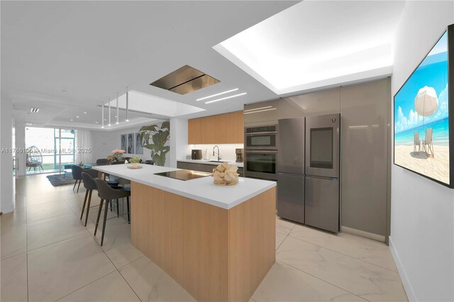 10700 NW 66th St Unit 103, Doral, FL 33178 - kitchen featuring stainless steel appliances, modern cabinets, light countertops, baseboards, and a center island