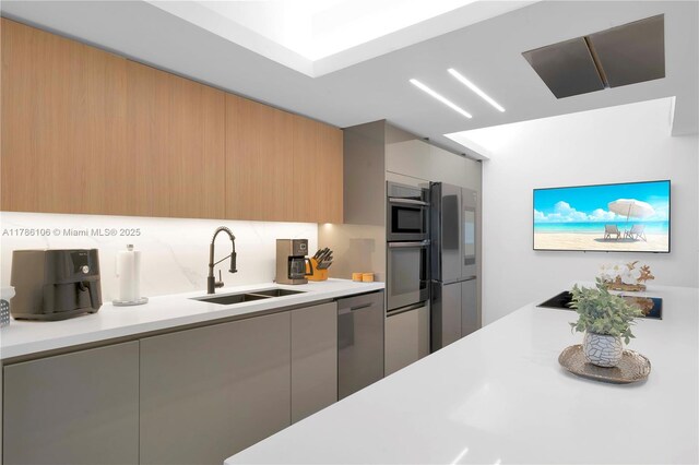 10700 NW 66th St Unit 103, Doral, FL 33178 - kitchen with a sink, appliances with stainless steel finishes, modern cabinets, and light countertops