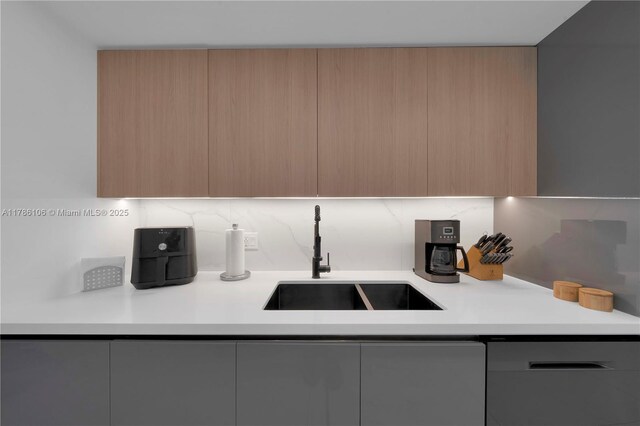 10700 NW 66th St Unit 103, Doral, FL 33178 - kitchen featuring modern cabinets, a sink, stainless steel dishwasher, and light countertops