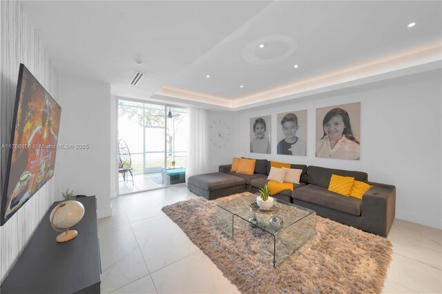 10700 NW 66th St Unit 103, Doral, FL 33178 - living area featuring a tray ceiling, recessed lighting, and baseboards
