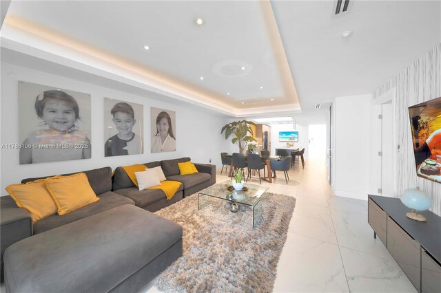 10700 NW 66th St Unit 103, Doral, FL 33178 - living area with a raised ceiling, recessed lighting, and light marble finish floors