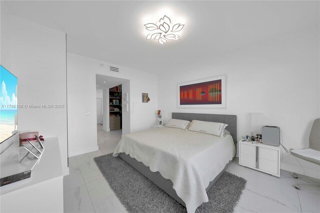10700 NW 66th St Unit 103, Doral, FL 33178 - bedroom with light marble finish floors