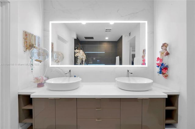 10700 NW 66th St Unit 103, Doral, FL 33178 - bathroom with double vanity, tiled shower, and backsplash