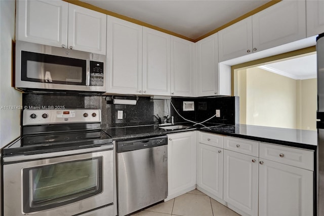 kitchen featuring white cabinets, dark countertops, and appliances with stainless steel finishes
