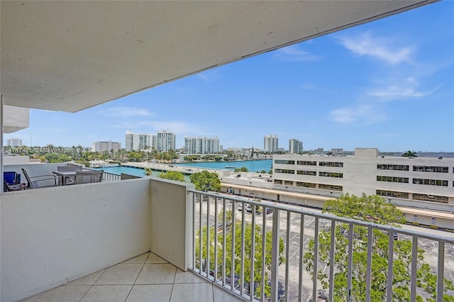 balcony featuring a view of city and a water view