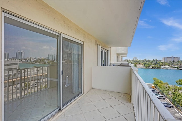 balcony featuring a city view and a water view