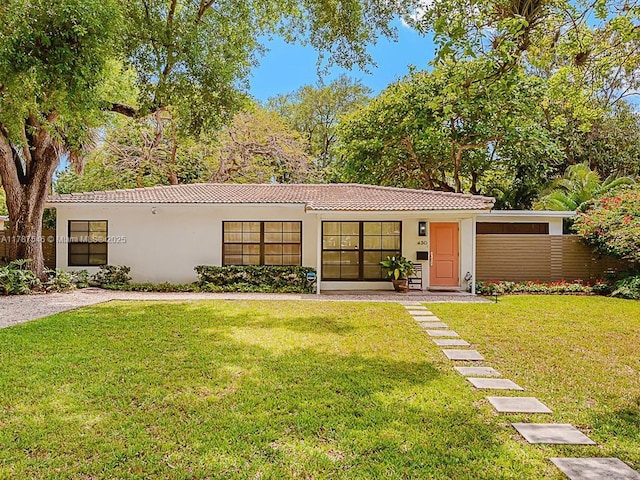430 NE 132nd Ter, North Miami, FL 33161 - view of front of property featuring a tile roof, a front lawn, and stucco siding