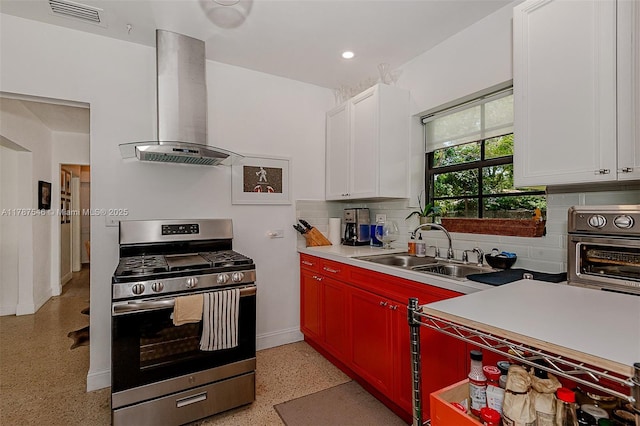 430 NE 132nd Ter, North Miami, FL 33161 - kitchen featuring a sink, light speckled floor, stainless steel gas range oven, visible vents, and ventilation hood