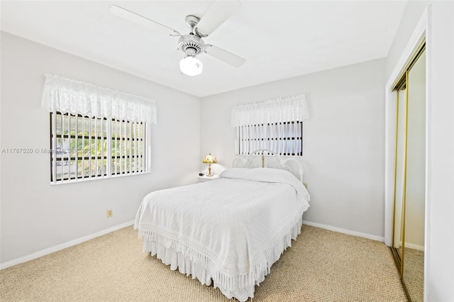 bedroom with carpet floors, a closet, a ceiling fan, and baseboards