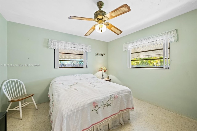 bedroom featuring speckled floor, baseboards, and ceiling fan