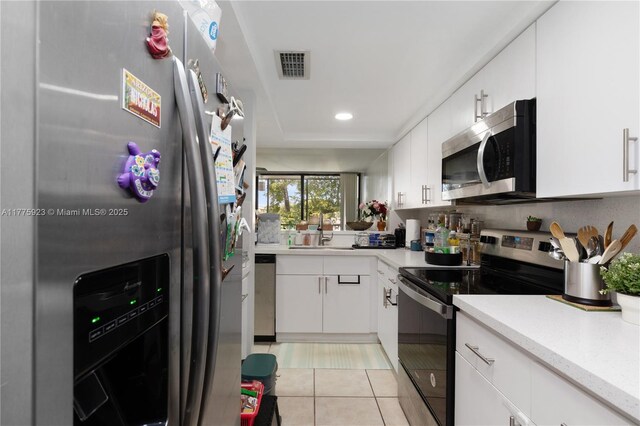 2801 SW 87th Ave Unit 1006, Davie, FL 33328 - kitchen with appliances with stainless steel finishes, a sink, light tile patterned flooring, white cabinets, and recessed lighting