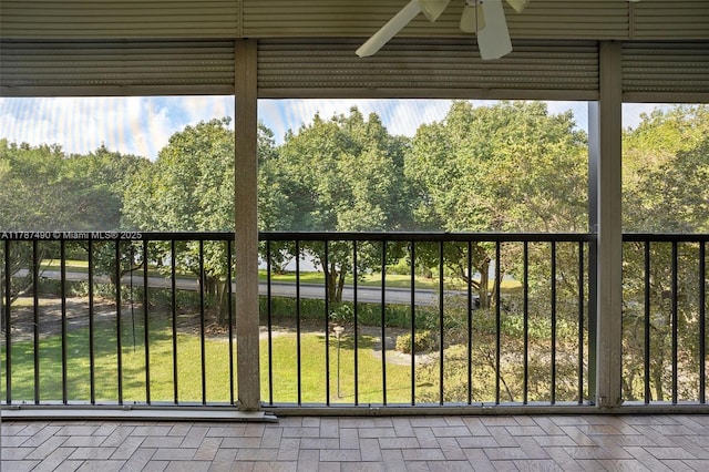 exterior space featuring brick floor, a healthy amount of sunlight, and ceiling fan