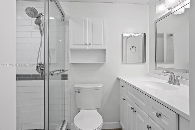 bathroom featuring vanity, toilet, and a stall shower