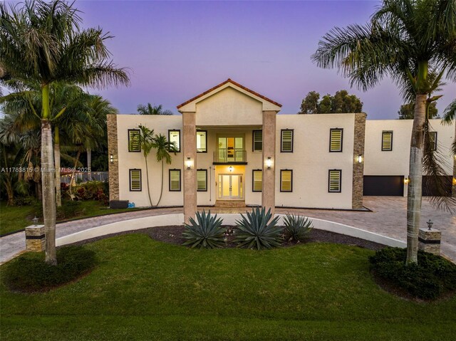 1430 NW 114th Ave, Plantation, FL 33323 - view of front of property featuring stucco siding, a yard, driveway, and french doors