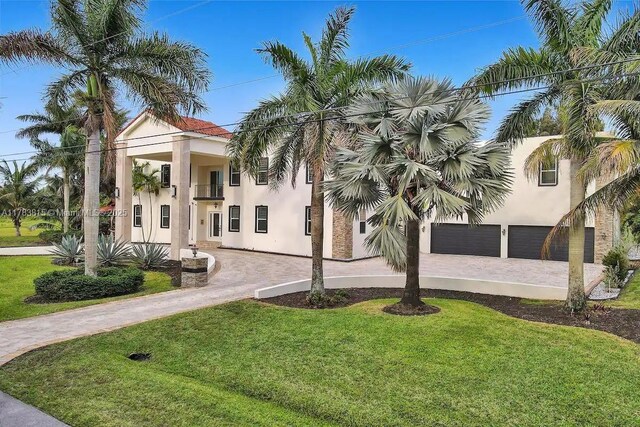 1430 NW 114th Ave, Plantation, FL 33323 - view of building exterior with curved driveway and an attached garage