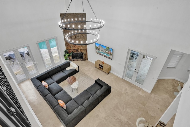 1430 NW 114th Ave, Plantation, FL 33323 - carpeted living room featuring french doors, a high ceiling, a chandelier, a fireplace, and baseboards