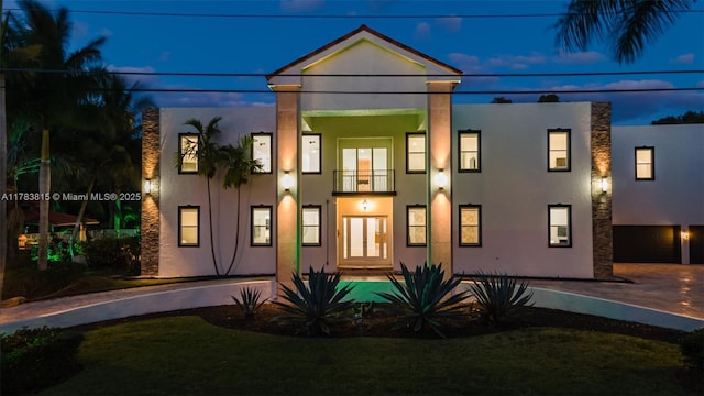 1430 NW 114th Ave, Plantation, FL 33323 - back of house at night featuring stucco siding