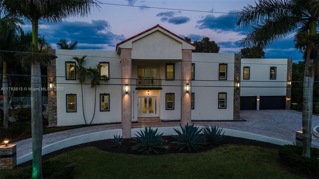 1430 NW 114th Ave, Plantation, FL 33323 - rear view of property with stucco siding, driveway, a garage, and french doors