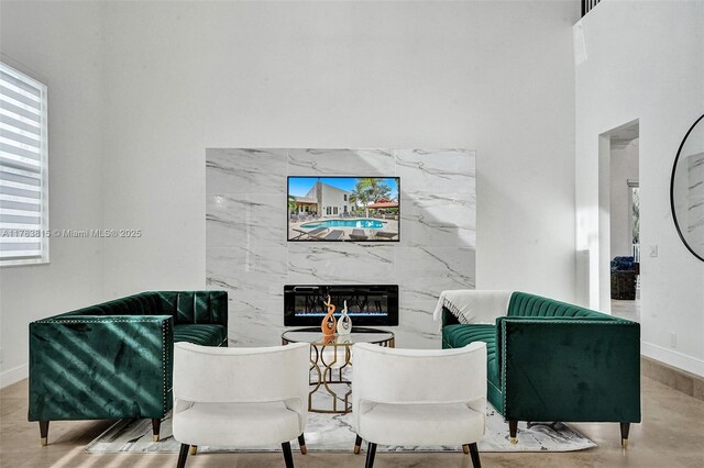 1430 NW 114th Ave, Plantation, FL 33323 - living area featuring a high end fireplace, baseboards, and a towering ceiling