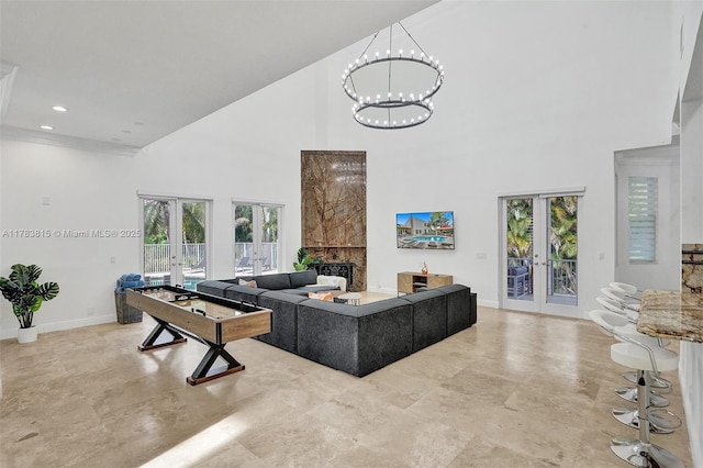 1430 NW 114th Ave, Plantation, FL 33323 - living area with french doors, a towering ceiling, baseboards, a high end fireplace, and a chandelier