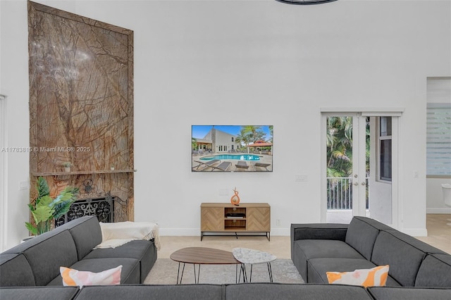 1430 NW 114th Ave, Plantation, FL 33323 - living room with a high ceiling, baseboards, french doors, and a fireplace
