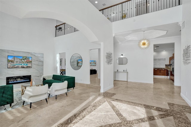 1430 NW 114th Ave, Plantation, FL 33323 - entrance foyer with arched walkways, baseboards, a towering ceiling, a fireplace, and inlaid floor details