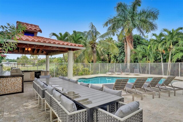 1430 NW 114th Ave, Plantation, FL 33323 - view of swimming pool with an outdoor kitchen, outdoor dining area, fence, and a patio area
