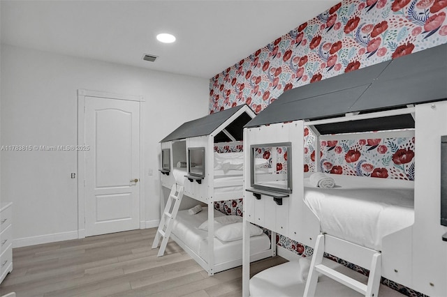 1430 NW 114th Ave, Plantation, FL 33323 - bedroom with wallpapered walls, wood finished floors, baseboards, an accent wall, and recessed lighting