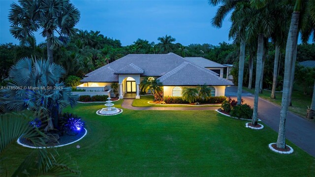 3152 SW 147th Ave, Davie, FL 33330 - view of front of property featuring a front lawn, curved driveway, stucco siding, and a tile roof