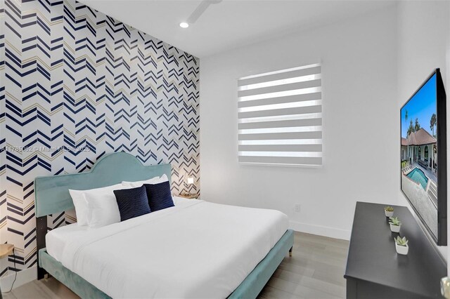 3152 SW 147th Ave, Davie, FL 33330 - bedroom featuring an accent wall, baseboards, recessed lighting, wood finished floors, and wallpapered walls