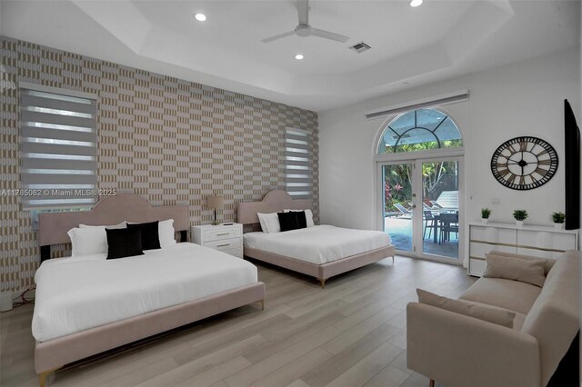 3152 SW 147th Ave, Davie, FL 33330 - bedroom with wallpapered walls, an accent wall, a tray ceiling, access to outside, and recessed lighting