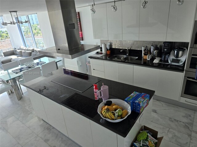 2950 NE 188th St Unit 501, Aventura, FL 33180 - kitchen featuring stainless steel oven, cooktop, modern cabinets, white cabinetry, and a sink