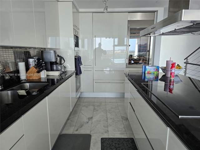 2950 NE 188th St Unit 501, Aventura, FL 33180 - kitchen featuring wall chimney range hood, white cabinets, and modern cabinets