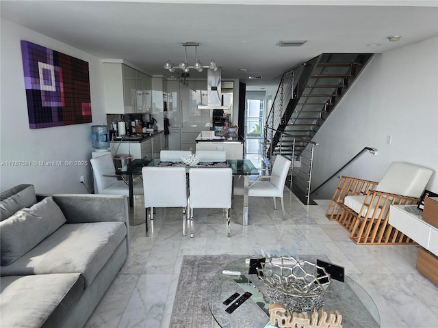 2950 NE 188th St Unit 501, Aventura, FL 33180 - living room featuring a chandelier, light marble finish floors, and stairway