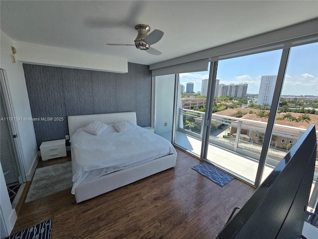 2950 NE 188th St Unit 501, Aventura, FL 33180 - bedroom featuring wood finished floors, access to outside, a ceiling fan, and a city view