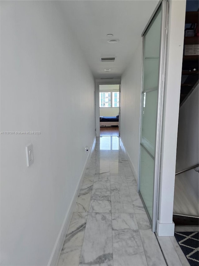 2950 NE 188th St Unit 501, Aventura, FL 33180 - hallway with light marble finish flooring and baseboards