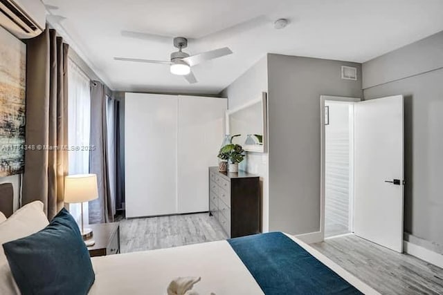 1321 S 16th Ave, Hollywood, FL 33020 - bedroom featuring a wall mounted air conditioner, wood finished floors, and ceiling fan