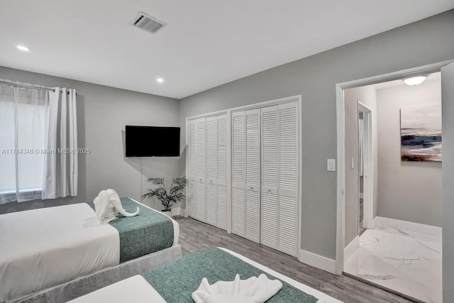 1321 S 16th Ave, Hollywood, FL 33020 - bedroom featuring baseboards, recessed lighting, wood finished floors, and multiple closets