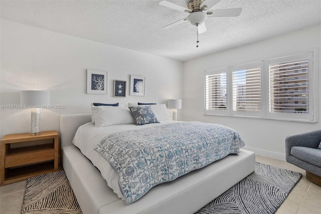 bedroom with tile patterned flooring, a textured ceiling, and ceiling fan