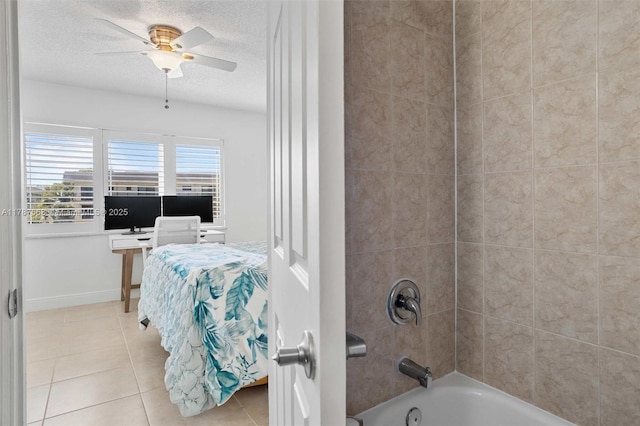 full bath with a ceiling fan, tile patterned floors, a textured ceiling, washtub / shower combination, and baseboards