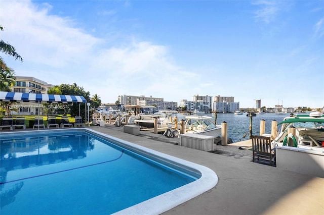 outdoor pool with a water view and a view of city