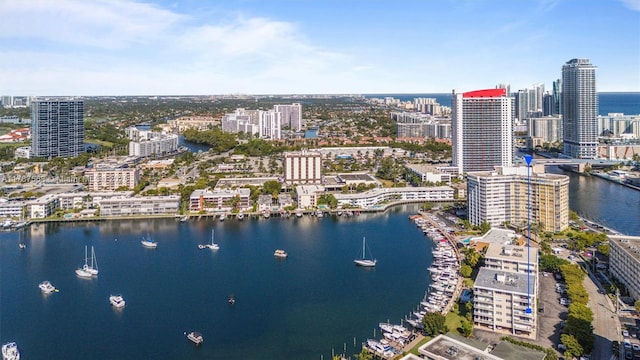 birds eye view of property with a water view and a view of city
