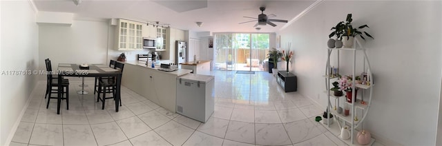 kitchen featuring stainless steel appliances, a ceiling fan, crown molding, a peninsula, and glass insert cabinets