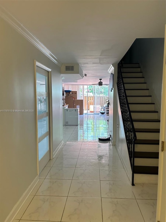 hall featuring stairway, marble finish floor, baseboards, ornamental molding, and visible vents