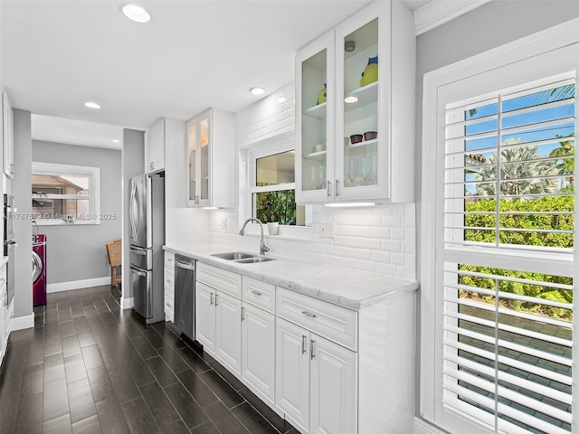 4231 NE 16th Ave, Oakland Park, FL 33334 - kitchen with appliances with stainless steel finishes, baseboards, a sink, plenty of natural light, and recessed lighting