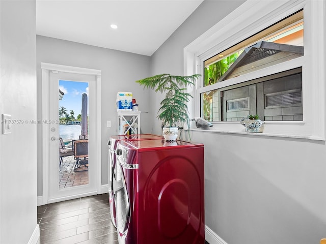 4231 NE 16th Ave, Oakland Park, FL 33334 - washroom featuring independent washer and dryer, healthy amount of natural light, baseboards, wood finished floors, and recessed lighting
