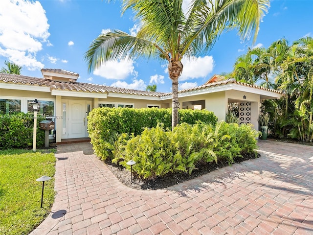 4231 NE 16th Ave, Oakland Park, FL 33334 - view of front of property with a tile roof and stucco siding