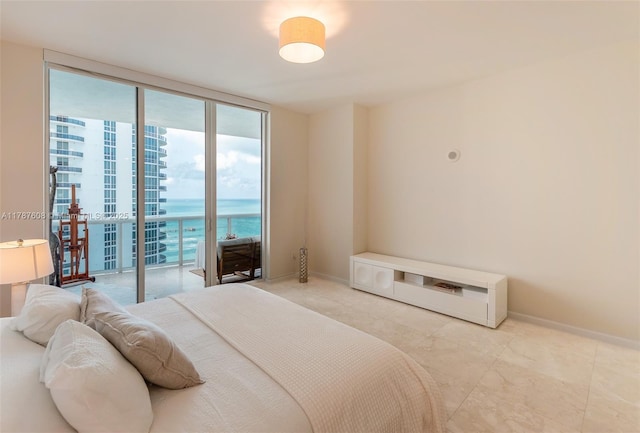 15901 Collins Ave Unit 2502, Sunny Isles Beach, FL 33160 - bedroom featuring expansive windows, baseboards, access to exterior, and a water view
