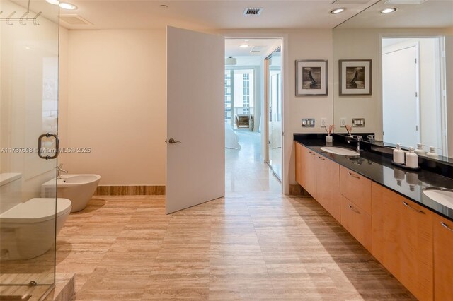 15901 Collins Ave Unit 2502, Sunny Isles Beach, FL 33160 - full bathroom with a sink, double vanity, toilet, a bidet, and visible vents